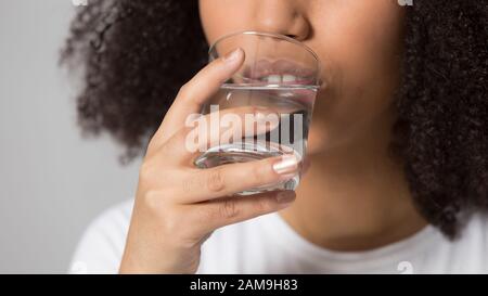 Close up head shot portrait african american lady drinking water. Stock Photo