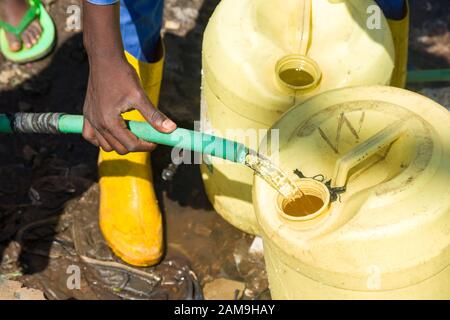 People filling bottles with water from the drinking fountains at ...