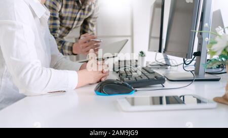 Young startup Programmers Sitting At Desks Working On Computers screen for Developing programming and coding to find solution to problem on New Applic Stock Photo
