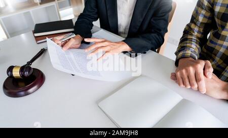 lawyer having meeting and consoling solution to his clients provide legal advice and trust commitment strain serious for problem, justice and attorney Stock Photo