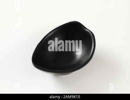 Curve black bowl for serving snacks and nuts Stock Photo
