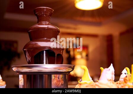 Chocolate fountain for halloween parties. Stock Photo
