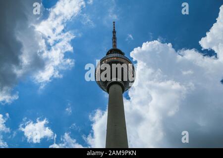 The detail of the famous TV tower in Berlin, one of the main sights of the city. Pictured against the cloudy sky in big contrast. Stock Photo