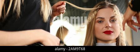 Beautiful Woman Getting Curly Hairstyle in Salon Stock Photo
