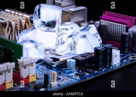Ice cubes cool the CPU on the motherboard. Overclocking  and cooling concept. Stock Photo