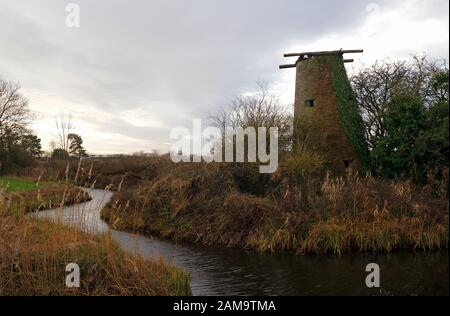 A view of the remains of Ludham Bridge Drainage Mill by a dyke by the River Ant on the Norfolk Broads at Ludham, Norfolk, England, UK, Europe. Stock Photo