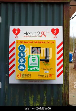 A life saving defibrillator in a public place by a boatyard in the Norfolk Broads in the village of Belaugh, Norfolk, England, United Kingdom, Europe. Stock Photo