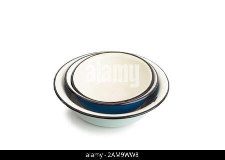 Pile of old enamel dishes, or bowls, isolated on white background Stock Photo