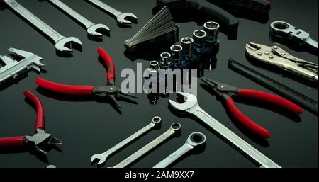 Set of mechanic tools. Chrome wrenches or spanners, hexagon socket, end cutter pliers, locking pliers, vernier caliper, pincers, feeler gauge, and tap Stock Photo