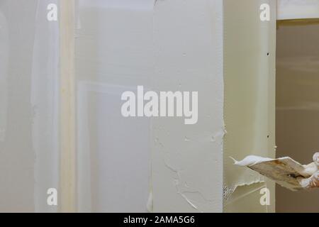 Work hand tool wall using plastering tool for unfinishing wall Stock Photo