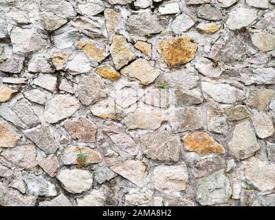 Natural stone wall texture  .  Old castle stone wall texture background . earth tone . rustic rough country decoration idea background for housing or Stock Photo