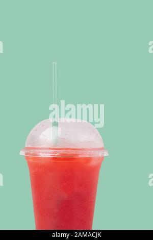 Raspberry syrup cocktail in take away cup with straw over white background Stock Photo