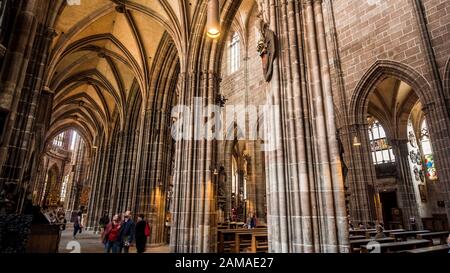 Nuremberg 2019. Interior nave of Cathedral of St. Lorenz, or Lawrence. We are on a Sunday and the faithful give way to visiting tourists. August 2019 Stock Photo