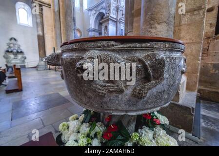 12th century Holy water font in Basilica Cathedral of Transfiguration in Cefalu city and comune located on the Tyrrhenian coast of Sicily, Italy Stock Photo