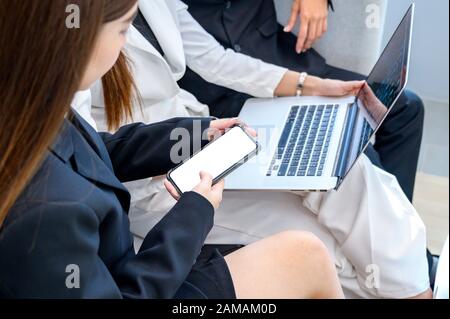 Business people are playing mobile phones and using computers Stock Photo