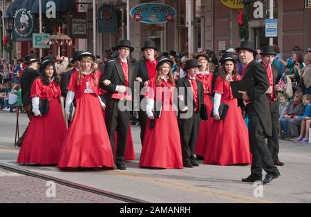 Carolers in Victorian period costumes at Dickens on The Strand parade, The Strand, Galveston, Texas, USA Stock Photo