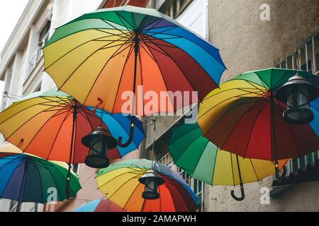 Multi-colored umbrellas hang overhead on a street in Istanbul in Turkey. Street decoration. Stock Photo