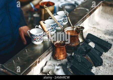 Cooking freshly flavored traditional Turkish charcoal coffee. Traditional turkish cuisine. Stock Photo
