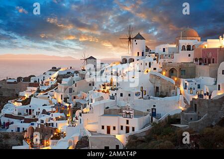 Sunset over Oia (ia), Cyclades Island of  Thira, Santorini, Greece.  The settlement of Oia had been mentioned in various travel reports before the beg Stock Photo