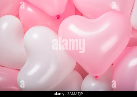 Happy valentines day greetings many heart shaped pink and white balloons background Stock Photo