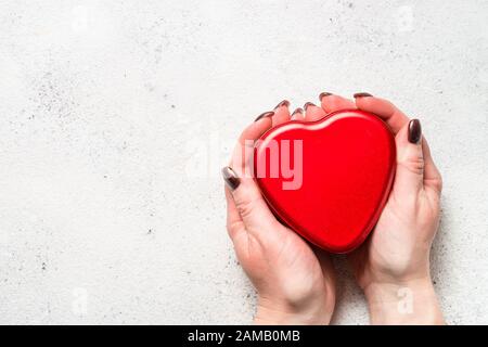 Red heart on white table top view. Stock Photo