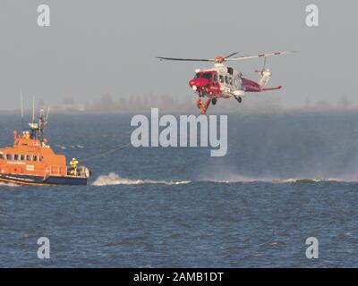 Sheerness, Kent, UK. 12th Jan, 2020. Sheerness All Weather Lifeboat 'George & Ivy Swanson' spent part of this afternoon training with the Coastguard Helicopter 163 in the Thames Estuary off Sheerness, Kent in a dramatic display involving the winchman landing onto the deck of the lifeboat at extremely close quarters. Credit: James Bell/Alamy Live News Stock Photo