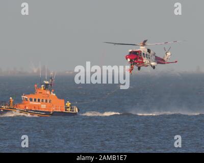 Sheerness, Kent, UK. 12th Jan, 2020. Sheerness All Weather Lifeboat 'George & Ivy Swanson' spent part of this afternoon training with the Coastguard Helicopter 163 in the Thames Estuary off Sheerness, Kent in a dramatic display involving the winchman landing onto the deck of the lifeboat at extremely close quarters. Credit: James Bell/Alamy Live News Stock Photo