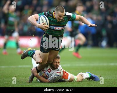 Northampton Saints Rory Hutchinson is tackled by Benetton Rugby's Marco Barbini during the Heineken Champions Cup pool one match at Franklin's Gardens, Northampton. Stock Photo