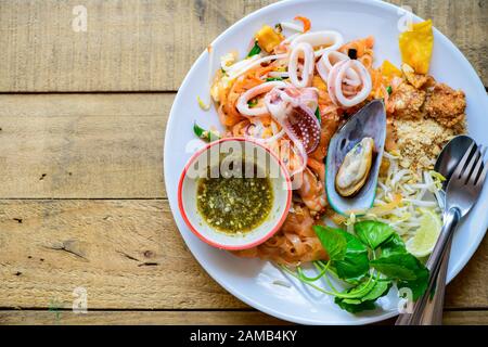 Stir-fried rice noodles (Pad Thai) with shrimp, mussels and squid on top view.Thailand's national dishes, Popular thai food Stock Photo
