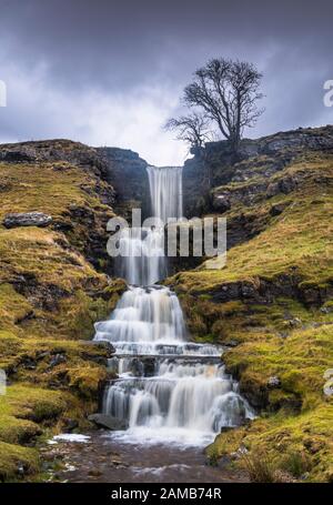 Standing in a rain & hail storm photographing the stunning cascading terraces of Cow Gill Waterfalls in Cray, Yorkshire Dales National Park. Stock Photo