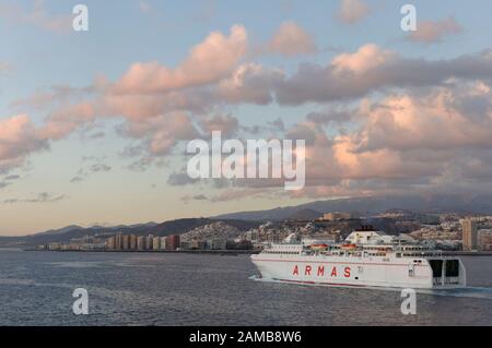 Stern view of the Volcan de Tamasite, an Inter Island Ferry heading out of Harbour at Dawn at Las Palmas in Gran Canaria. Stock Photo