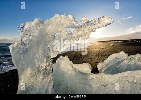 Block of ice, beach at glacier lagoon Joekulsarlon,  Breiðamerkursandur, south coast Iceland, Iceland Stock Photo