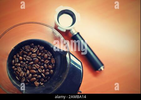 Beautiful freshly roasted coffee beans in a coffee grinder. Stock Photo
