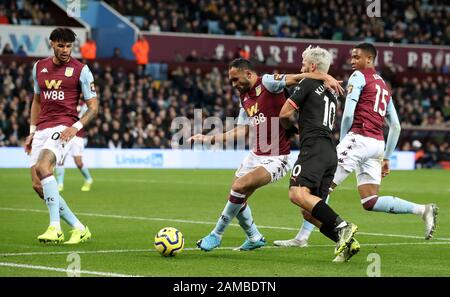 Aston Villa's Ahmed Elmohamady (centre left) and Manchester City's Sergio Aguero (centre right) during the Premier League match at Villa Park, Birmingham. Stock Photo