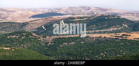 panorama of the israel lebanon border from adir mountain viewpoint showing the stark contrast in vegetation between the two countries Stock Photo