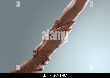 Tho hands holding, help, assist, support and trust concept Stock Photo