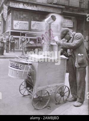 Roast Corn Man Peering Into Cart Basket On The Front Other Peddlers Clothing Stores Beyond Stock Photo Alamy