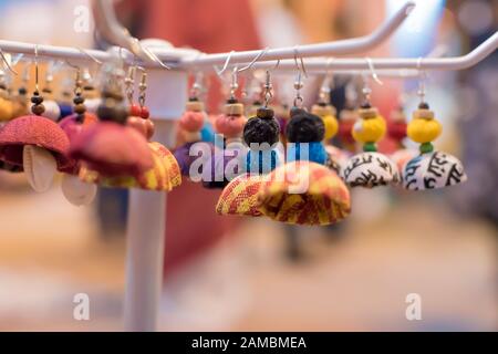 Indian Traditional Handmade earrings with blurred background is displayed in a street shop for sale. Indian handicraft and art Stock Photo