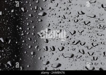 Large water droplets and condensation on backlit glass pane Stock Photo