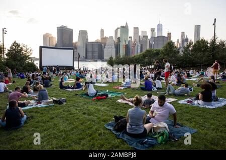 NEW YORK, USA - AUGUST 25, 2017: Unidentified people at Brooklyn Bridge Park free outdoor movies projection in New York. Move projections, named Movie Stock Photo