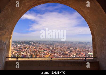 Panoramic view of the city of Naples through the arch of the medieval fortress Castel Sant'Elmo. Skyline with historical Old town, Spaccanapoli street. Stock Photo