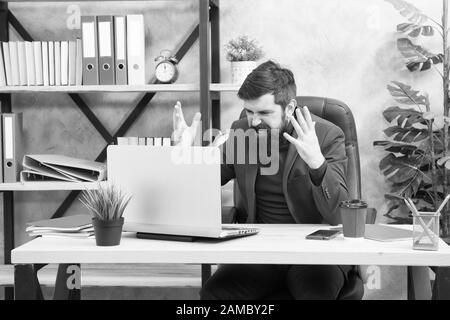 Got into mess. Man bearded boss manager sit office with laptop. Manager solving business problems online. Business man failed. Risky business. Broker and financial indicators. Falling stock prices. Stock Photo