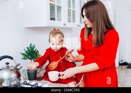 Mom and daughter in the kitchen in a bright apartment or house. Stock Photo