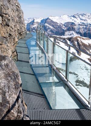Thrill Walk at Birg in the Swiss Alps. The steel structure hugs the cliff side and there is a vertical drop beneath. Stunning views of the mountains. Stock Photo