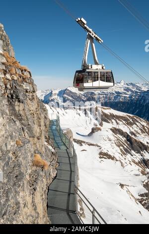 Thrill Walk at Birg in the Swiss Alps. The steel structure hugs the cliff side and there is a vertical drop beneath. Stunning views of the mountains. Stock Photo