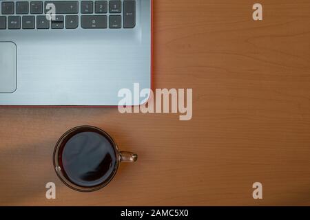 Office composition with laptop and coffee on wooden desk Stock Photo