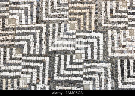 Geometric mosaic made from stone. Antique pattern. Stock Photo
