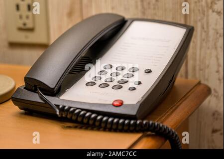 A somewhat old-fashioned landline tabletop touchtone phone with push-buttons