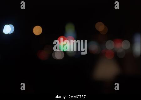 Multi-colored, blurry bokeh balls at night Stock Photo