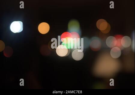 Multi-colored, blurry bokeh balls at night Stock Photo